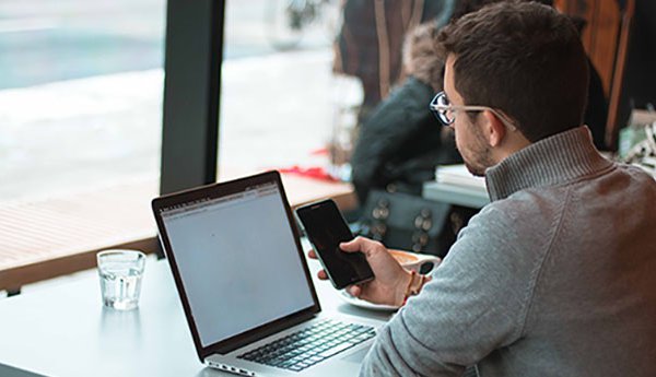 Man looking at super account on laptop