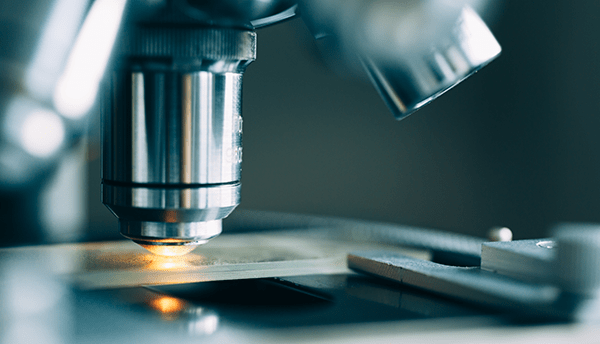 Microscope with metal lens at a healthcare and biotech laboratory