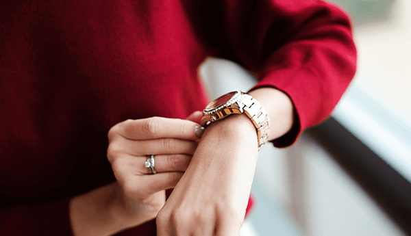 Woman looking at her watch as the end of financial year approaches