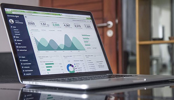 Business laptop with graphs and data